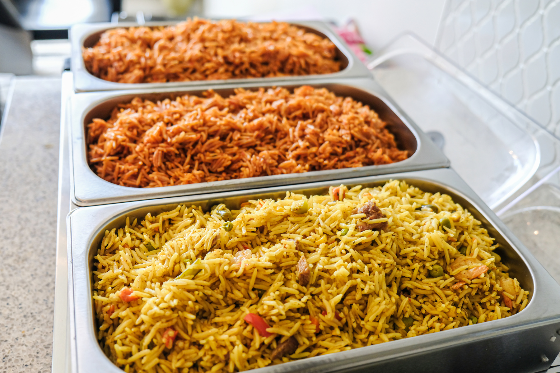 Nigerian Jollof and Vegetable Fried Rice served in Chaffing dish